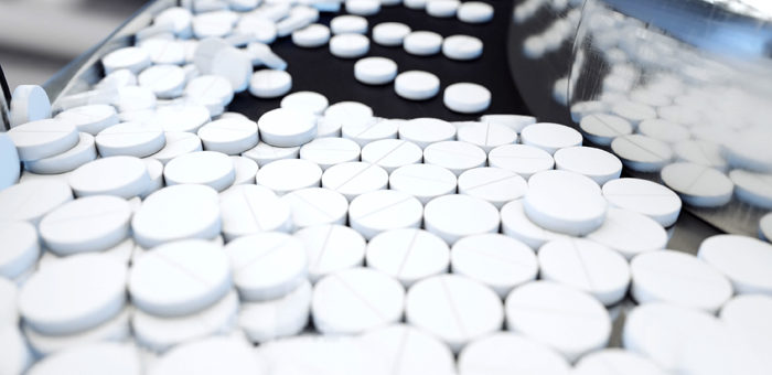 individual white pills being sorted